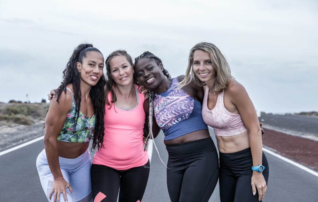 Women in fitness apparel smiling after workout