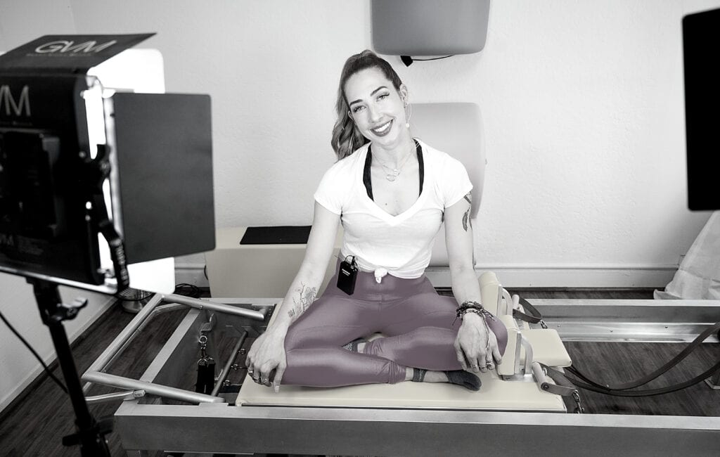 Lesley Logan, Pilates business/studio owner recording her Pilates exercises inside her studio