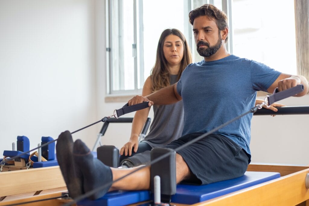 Man working out with Pilates reformer