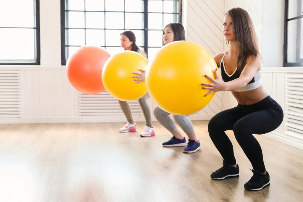 Pilates clients doing indoor exercise