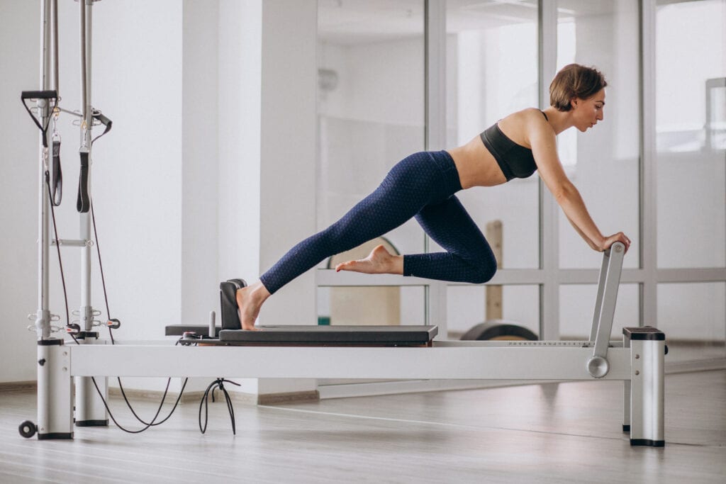 Woman practicing Pilates on reformer