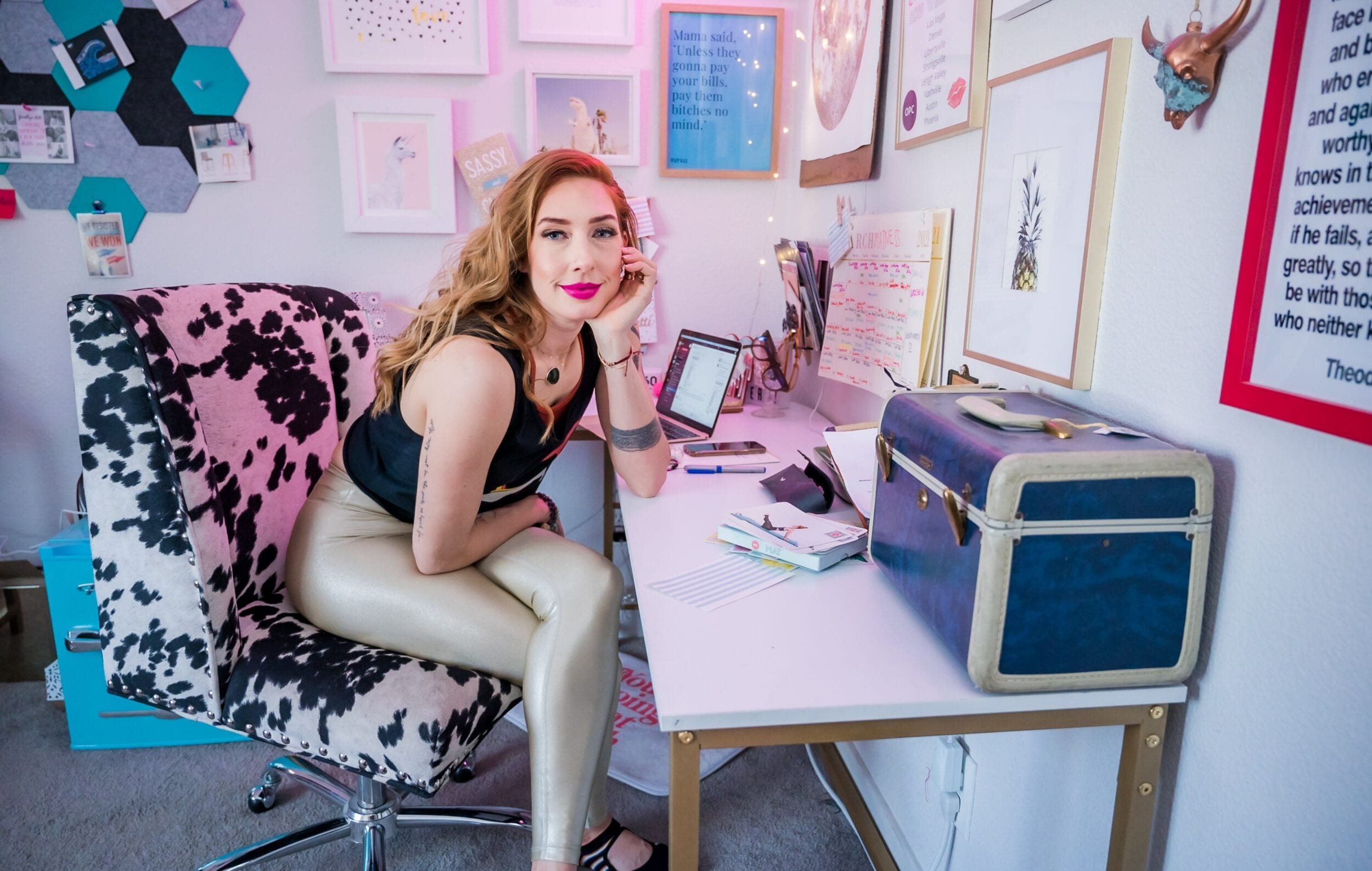 Lesley Logan, Pilates business/studio owner smiling while sitting in front of her office desk